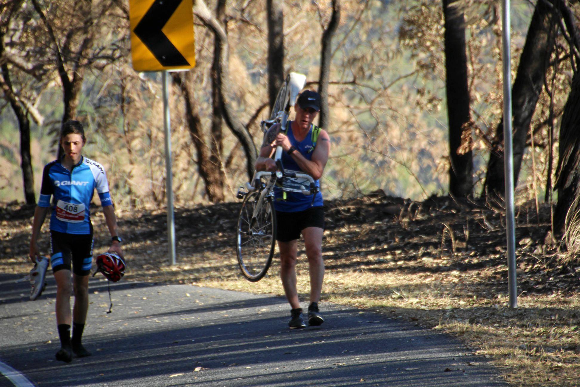 Runner Lee Pratt stops to help a cyclist finish Challenge the Mountain. Picture: Rockhampton Photography Club