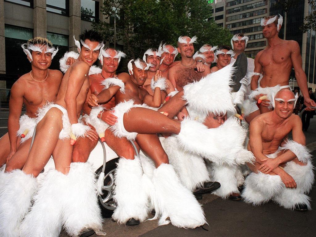 Scantily-clad partygoers pose for a photo during the street parade in Sydney. Picture: Steve Morenos