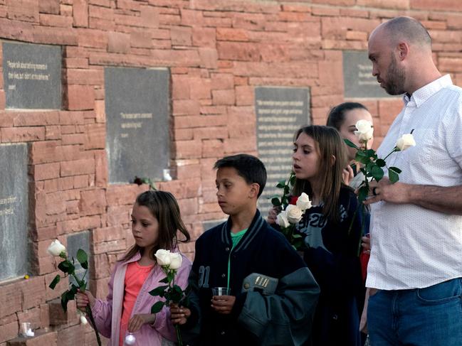 A Columbine High School massacre survivor and his family visit the Columbine Memorial in Littleton, Colorado, during a community vigil for the 20th anniversary of the Columbine High School mass shooting. Picture: AFP