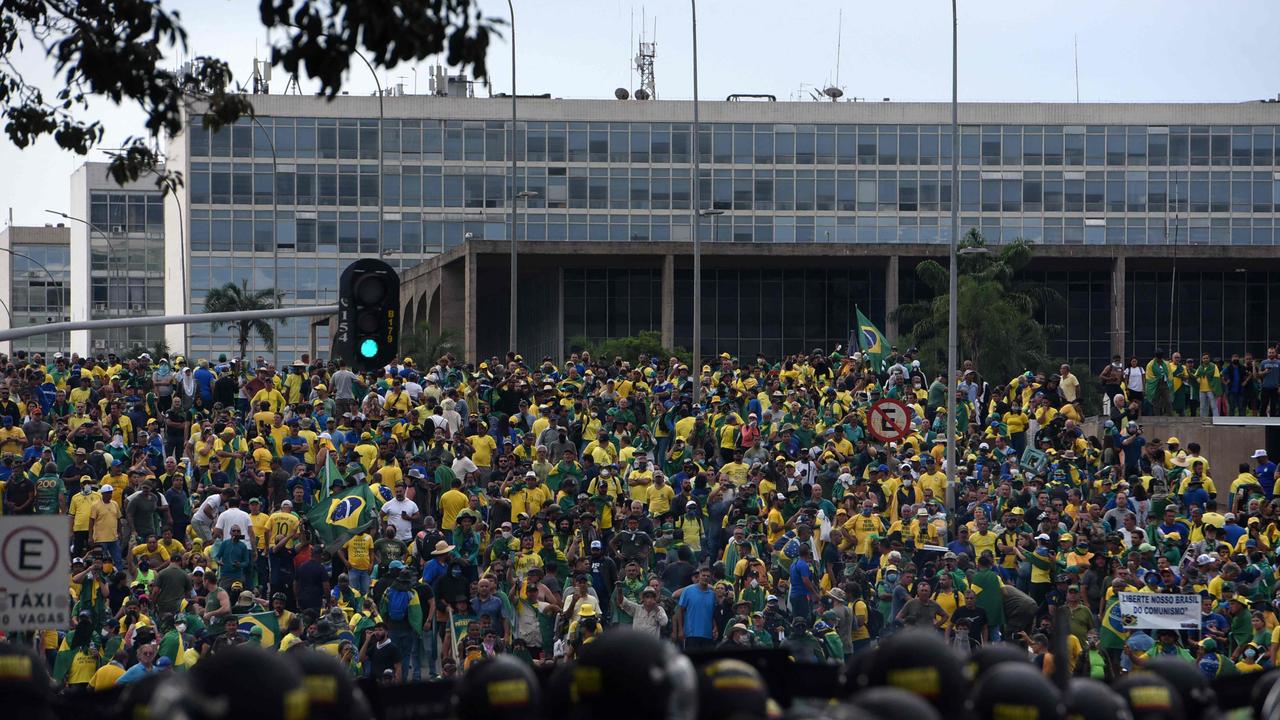 Supporters of Brazilian former President Jair Bolsonaro invading several government buildings are confronted by security forces. Picture: AFP