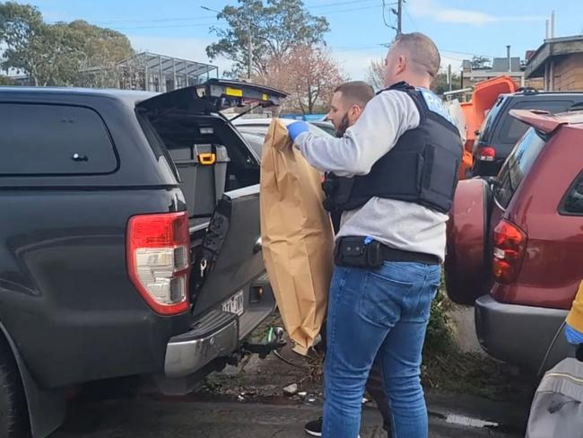 Transit Divisional Response Unit detectives seizing stolen plates and an allegedly stolen MG following the arrest of a man in Springvale on Tuesday. relates to an investigation into the theft of more than 70 catalytic converters across Melbourne. Picture: VIC POLICE