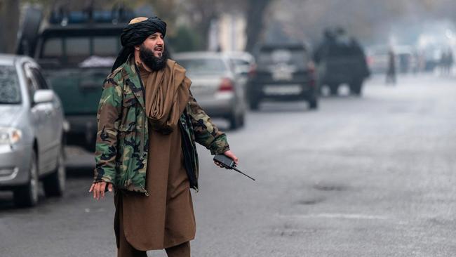 A member of the Taliban security forces walks near a site of an attack at Shahr-e-naw which is city's one of main commercial areas in Kabul on December 12, 2022. – A loud blast and gunfire were heard in the Afghan capital December 12 near a guesthouse popular with Chinese business visitors, a witness said. (Photo by Wakil KOHSAR / AFP)