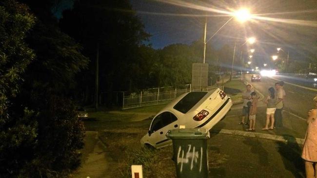 No one was injured when a car took a wrong turn off Ballina Rd at Lismore Heights on Wednesday and ended up perched precariously on an almost vertical slope. Photo: Rodney Stevens. Picture: Photo: Rodney Stevens