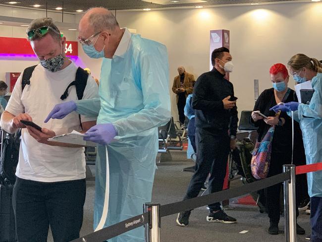 NSW Health workers screen passengers arriving at Sydney Airport from Perth on Saturday. Picture: NCA NewsWire/Bianca De Marchi