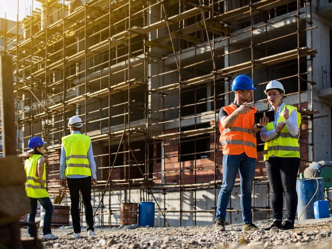 Four construction workers having meeting