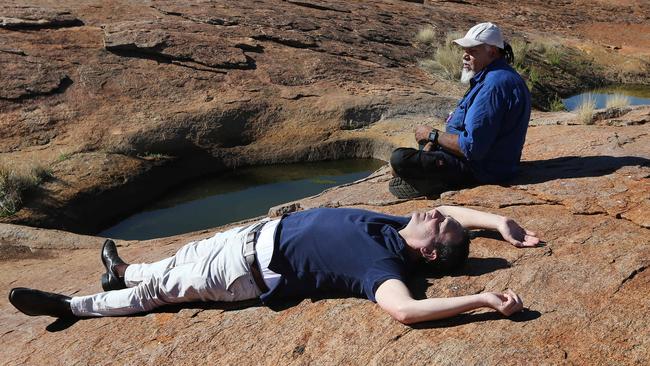 Opposition Leader Steve Marshall and Aboriginal elder Lee Brady relax under the sun near rock pools in the APY Lands. Picture: Dylan Coker