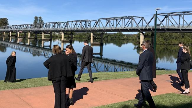 Magistrate Erin Kennedy turns back as the other parties go down to river's edge on the first day of the inquest into the death of Brandon Clark who drowned in the Manning River in January last year. Picture: Janine Watson