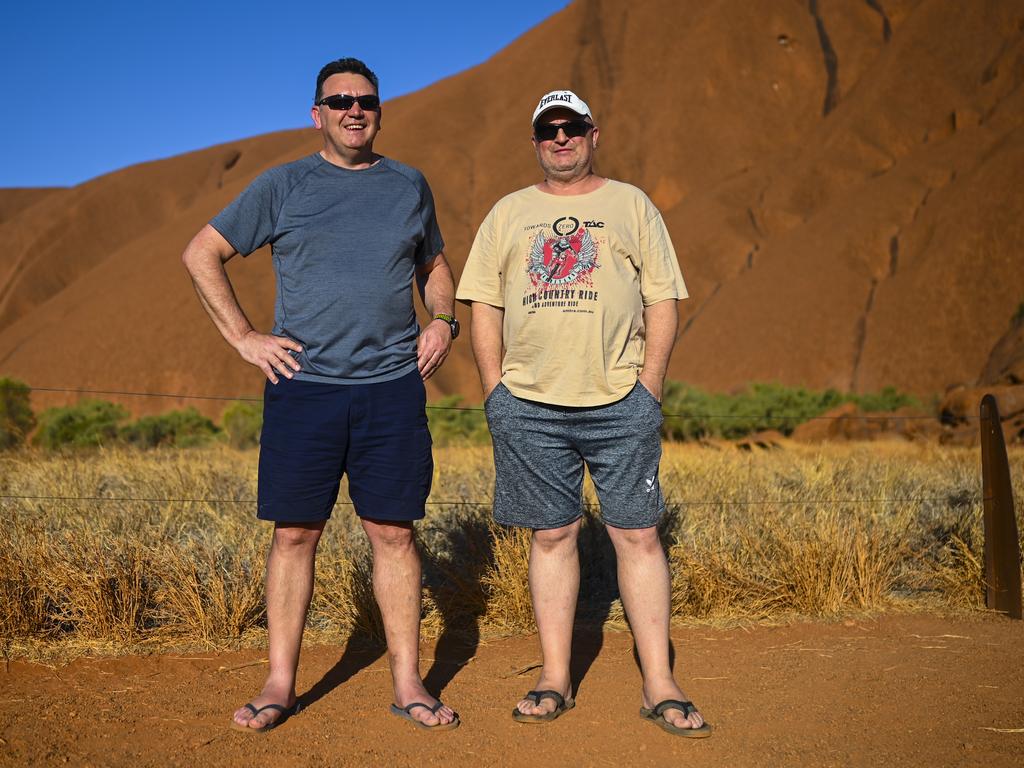 Jeff Lis and Stefan Gangur pose for photographs ahead of climbing Uluru, also known as Ayers Rock at Uluru-Kata Tjuta National Park in the Northern Territory, Thursday, October 10, 2019. Picture: Lukas Coch/AAP