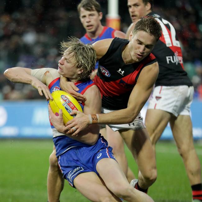 Cody Weightman is tackled high by Bomber Matt Guelfi.