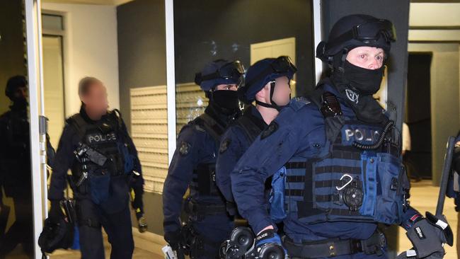 Police Drug raids in Richmond and Carlton. "Operation Mergers" Critical Incident Response Team members leaving the Drummond Street flats.Picture: Tony Gough