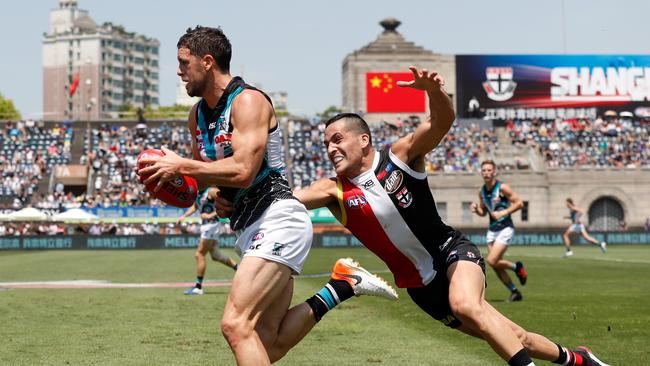 Port Adelaide’s Travis Boak tries to evade the tackle of St Kilda’s Shane Savage during last year’s China match at Jiangwan Stadium. Picture: Michael Willson (AFL Photos)