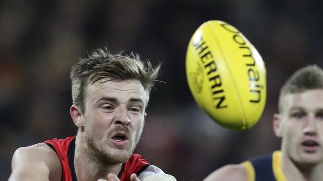 Marty Gleeson gets away a handpass for Essendon.