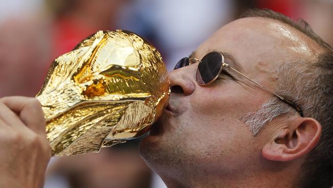 An England fan kisses a replica of the World Cup trophy before kick off at Samara Arena. Photo: AP