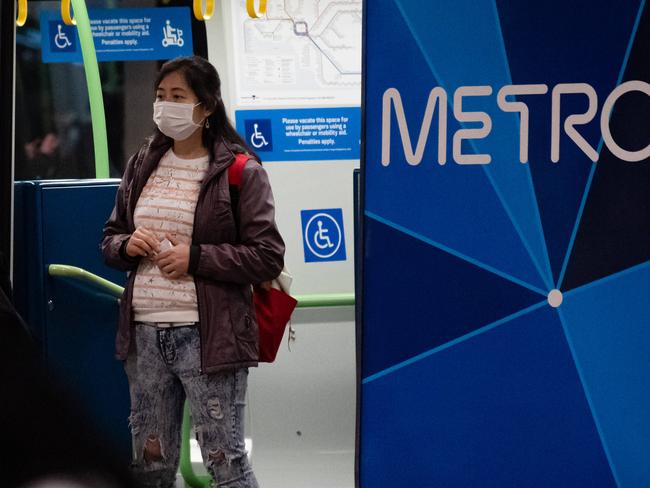 Passengers wear surgical masks to stay safe against Covid-19 on trains and at stations in Melbourne. Flinders Street station pictured. Picture: Jason Edwards