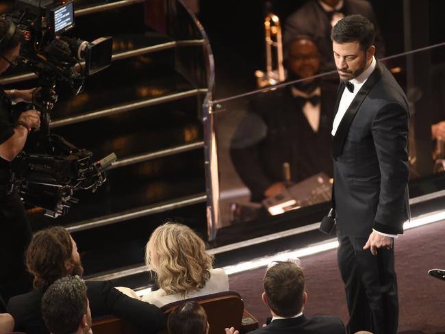 Oscars host Jimmy Kimmel glares at his ‘enemy’ Matt Damon after he tripped him. Picture: AP