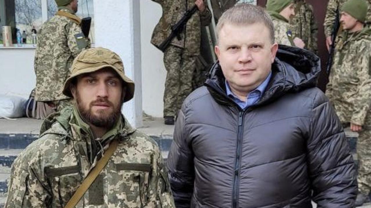 Ukrainian boxer Vasily Lomachenko (L) in battle fatigues.