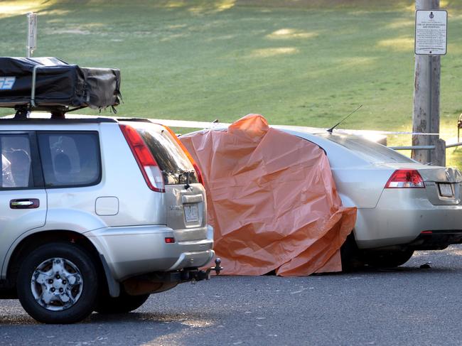 Police investigate after a person was struck and killed by a car while attending a rave at a park in Kooyong. Picture: Andrew Henshaw