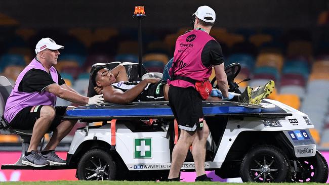 Quaynor had to be stretchered off after his leg was cut by the illegal boot. Picture: Getty Images