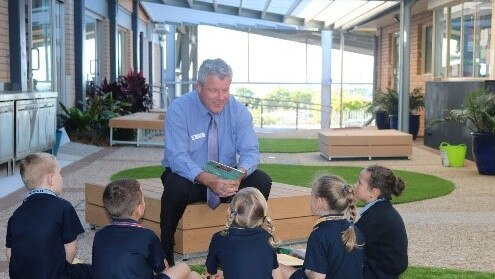 Our Lady of the Rosary School principal Dr Michael Stewart reading to students.