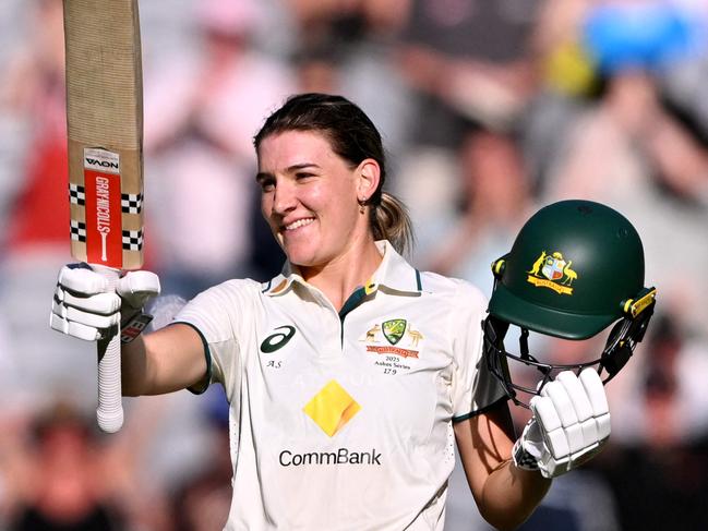 Australia's Annabel Sutherland celebrates scoring her century during the second day of the Women's Ashes cricket Test match between Australia and England at the Melbourne Cricket Ground (MCG) in Melbourne on January 31, 2025. (Photo by William WEST / AFP) / --IMAGE RESTRICTED TO EDITORIAL USE - STRICTLY NO COMMERCIAL USE--