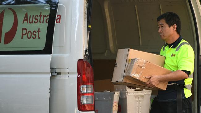 SYDNEY, AUSTRALIA - NCA NewsWire Photos OCTOBER, 01, 2020: An Australia Post worker unloads packages at the Australia Post outlet in Surry Hills. Picture: NCA NewsWire/Joel Carrett