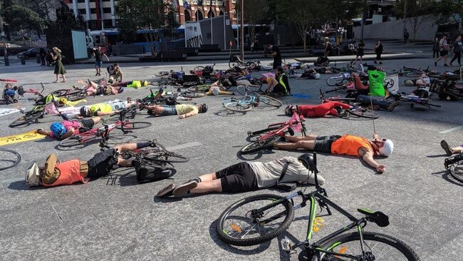 Extinction Rebellion cyclists stage a die-in in Brisbane's King George Square. Picture: Sarah Matthews