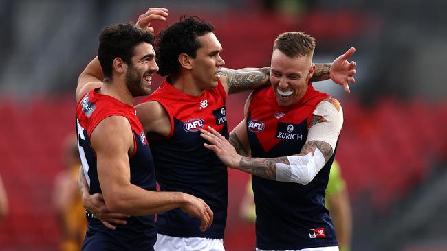 Melbourne’s Harley Bennell, centre, celebrates a goal with Christian Petracca, left, and James Harmes at Giants Stadium. Picture: Getty Images