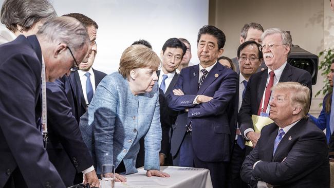 CHARLEVOIX, CANADA - JUNE 9:   In this photo provided by the German Government Press Office (BPA), German Chancellor Angela Merkel deliberates with US president Donald Trump on the sidelines of the official agenda on the second day of the G7 summit on June 9, 2018 in Charlevoix, Canada. Also pictured are (L-R) Larry Kudlow, director of the US National Economic Council, Theresa May, UK prime minister, Emmanuel Macron, French president, Angela Merkel, Yasutoshi Nishimura, Japanese deputy chief cabinet secretary, Shinzo Abe, Japan prime minister, Kazuyuki Yamazaki, Japanese senior deputy minister for foreign affairs, John Bolton, US national security adviser, and Donald Trump. Canada are hosting the leaders of the UK, Italy, the US, France, Germany and Japan for the two day summit. (Photo by Jesco Denzel /Bundesregierung via Getty Images)