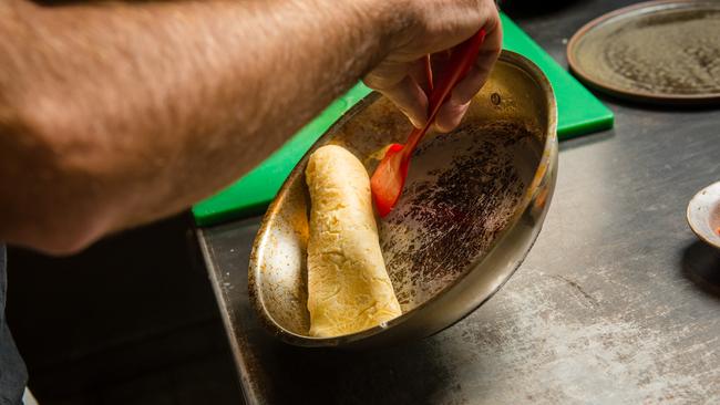 Roll the omelette out of the pan to form a tight cigar shape. Picture: Eugene Hyland