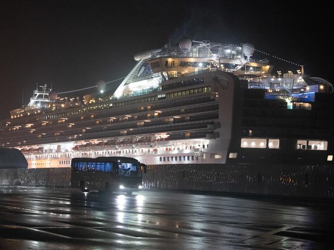 Buses carry American citizens from the quarantined Diamond Princess cruise ship at Daikoku Pier. Picture: Getty Images