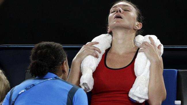 Simona Halep is checked on by the physio during the women’s final.