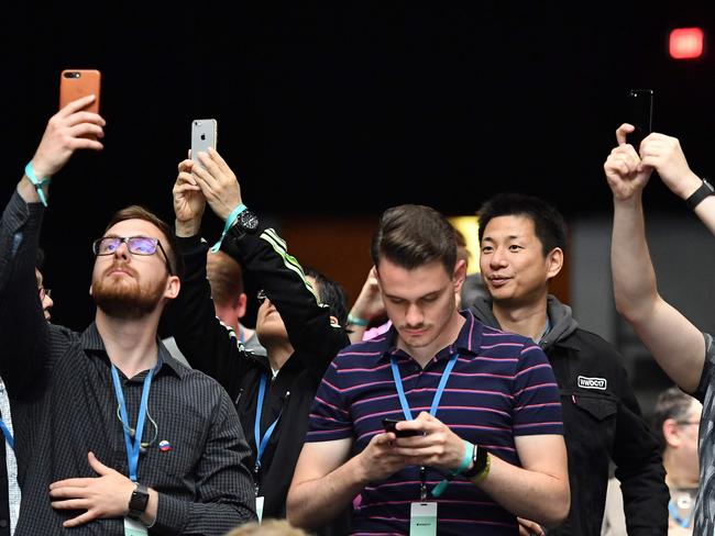 Attendees take photos at San Jose McEnery Convention Center during Apple's Worldwide Developers Conference. Picture: Josh Edelson/AFP