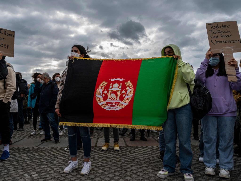 Women display an Afghan flag as they demonstrate in front of the Reichstag building, seat of the Bundestag lower house of parliament, in Berlin on August 17. Picture: AFP