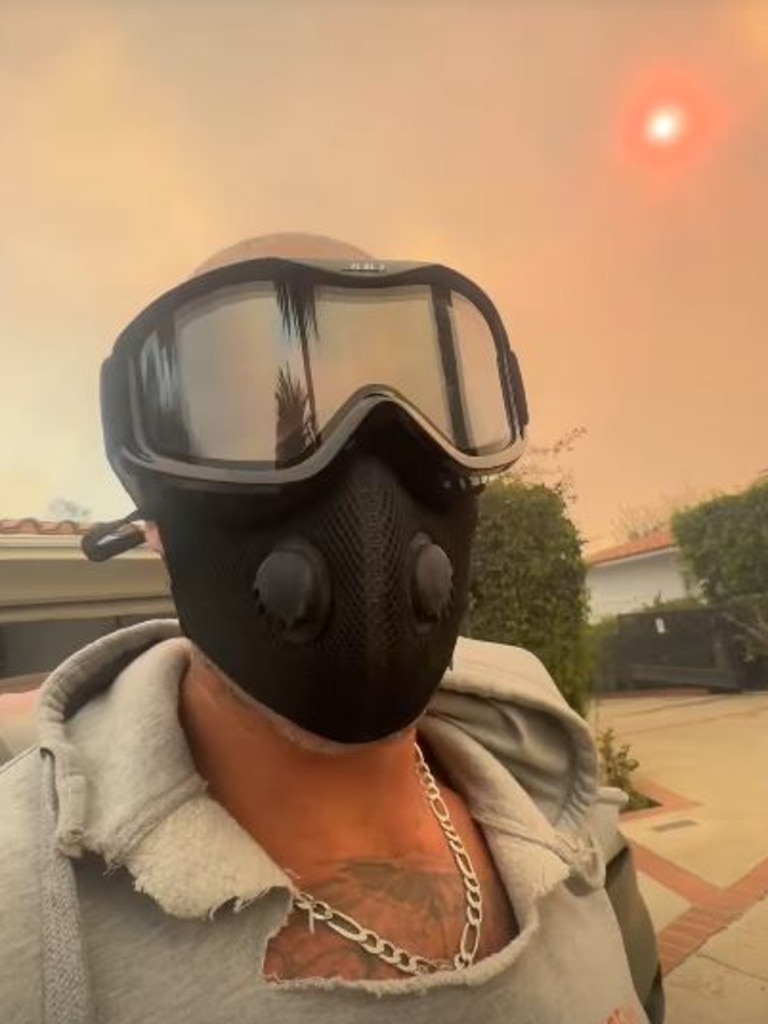 Cohen emerged with a gas mask in one clip as fires burned.