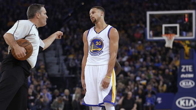 Golden State Warriors' Stephen Curry listens to referee Monty McCutchen during the first half.