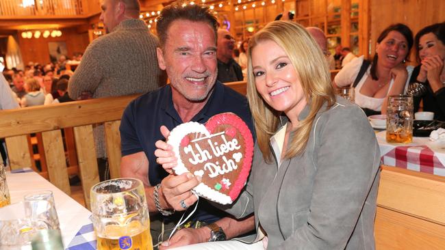 Arnold Schwarzenegger and his girlfriend Heather Milligan visit the Schuetzen Festzelt during the Oktoberfest at Theresienwiese on September 27, 2016 in Munich, Germany.