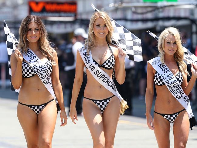 Miss V8 Supercars winners l-r 2nd Cassandra Jade Dimitriadis, winner Stella Badenoch from Adelaide and 3rd Gemma Rose from Coolangatta walk through the pits during Day 3, Sunday of the GC 600 through the streets of Surfers Paradise. Pics Adam Head