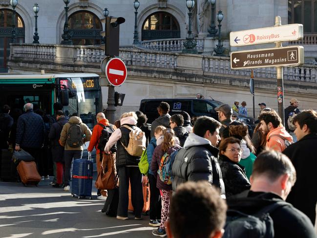 Some people have been lining up for hours in an attempt to catch a bus to their destination. Picture: AFP