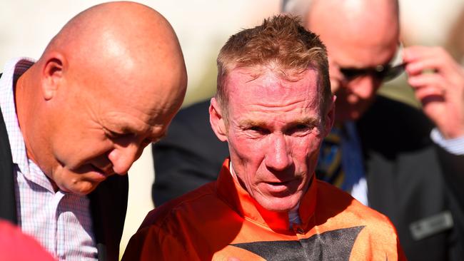 Jockey Jim Byrne speaks to trainer Stephen Lee after riding Pleased to win at Doomben this season. Photo: Albert Perez, AAP Image.