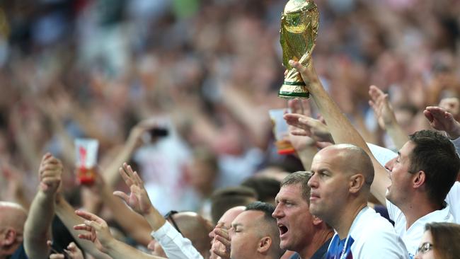 England fans hold up a World Cup replica as they cheer on their team at the Luzhniki Stadium in Moscow. Photo: Getty Images