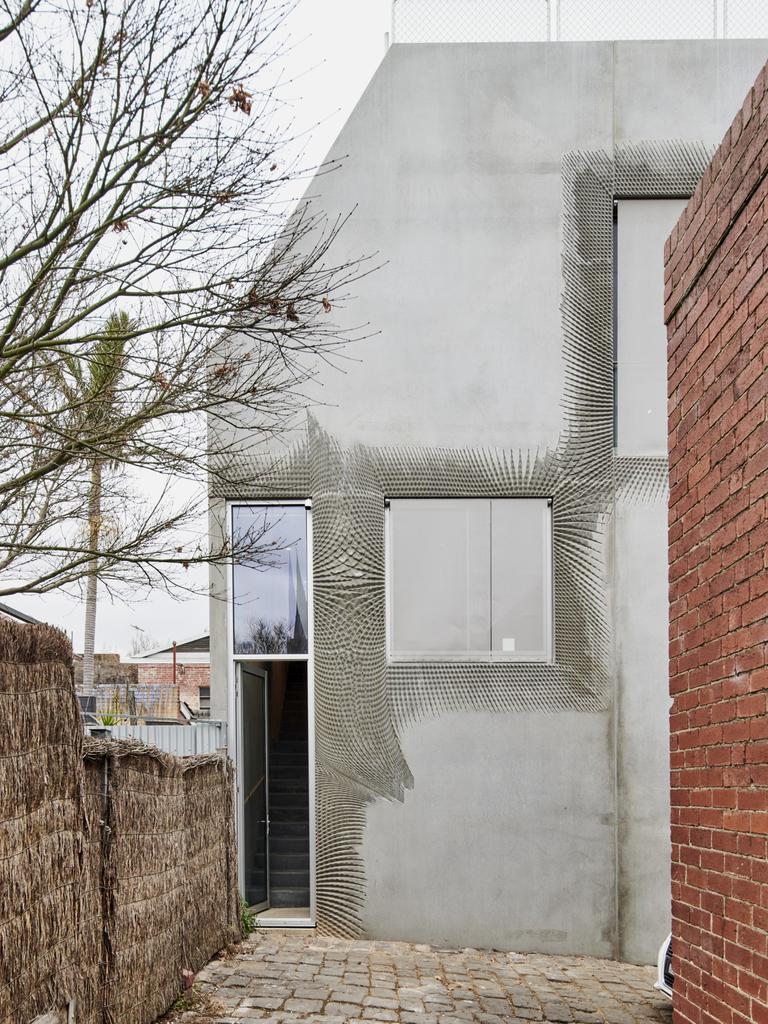 This tiny 8m x 8m North Melbourne Brutalist home is positioned at the end of the cul de sac.