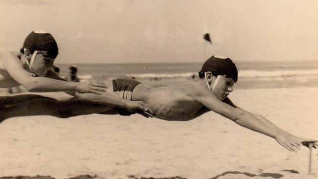 Original Southport nipper Darryl Hurley reaching for a beach flag.