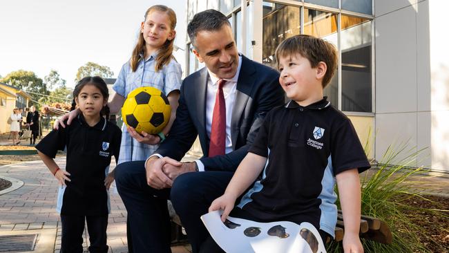 Primary School students Allegra, 5, Macey, 9, Premier of South Australia Peter Malinauskas and student Jackson, 6, at Avenues College. Picture: NCA NewsWire / Morgan Sette