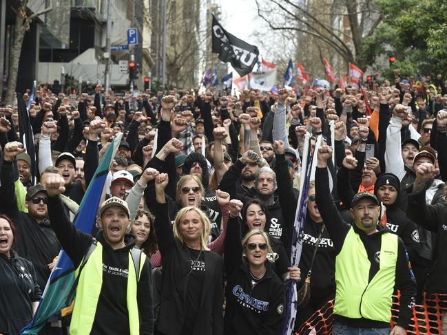 The march stops outside the Fair Work Commission. Picture: Andrew Henshaw