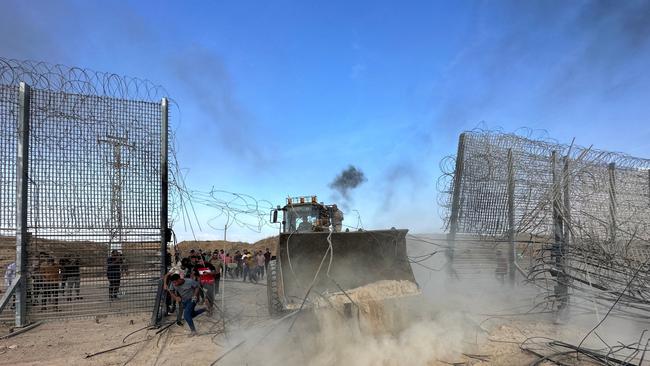 Palestinians break into the Israeli side of Israel-Gaza border fence after gunmen infiltrated areas of southern Israel, Picture: Mohammed Fayq Abu Mostafa / Reuters