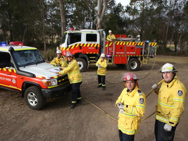 Members of the NSWRFS Horsley Park Rural Fire Brigade (L-R) Ben Robb, Anthony Ciccaldo, Frank Harris, Ethan Makin, Captain Darren Nation and Corey Lyons pose for a photo at Horsley Park, Thursday, 23rd August 2018. (AAP Image / Robert Pozo).