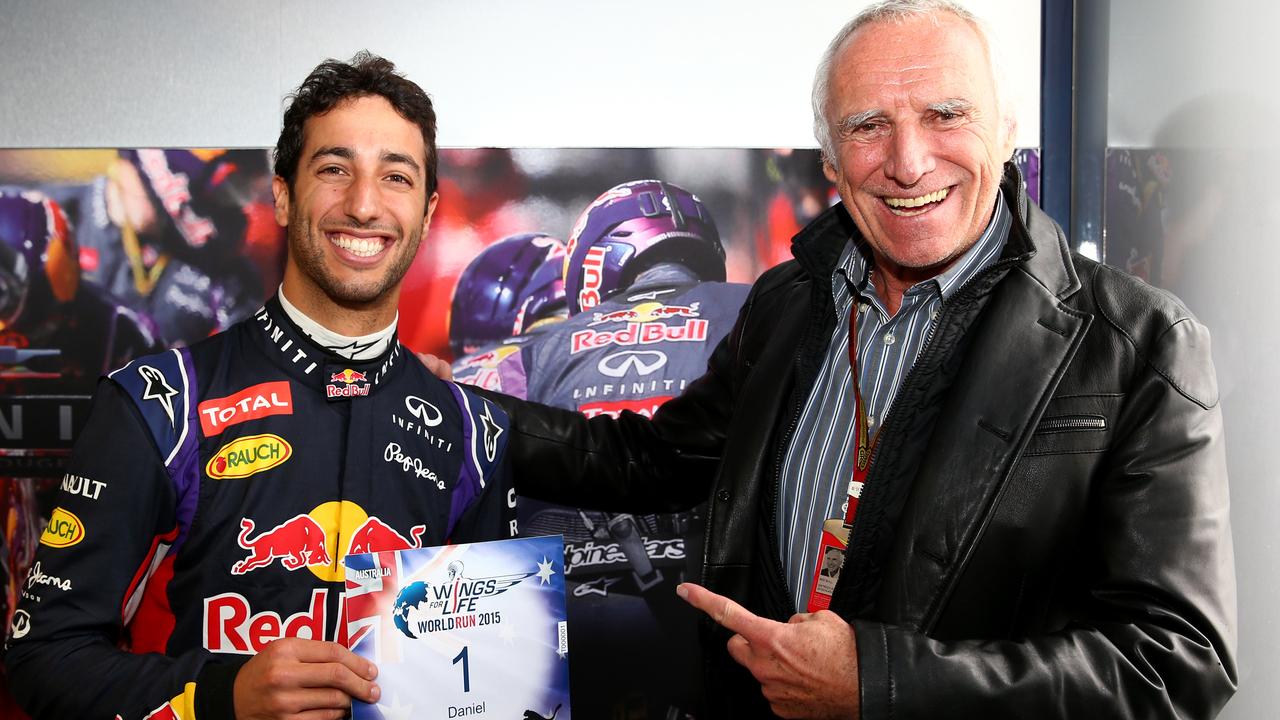 JEREZ, SPAIN - FEBRUARY 03: (Free picture for editorial usage) Red Bull Racing's driver Daniel Ricciardo of Australia receiving bib number 1 for the "Wings of Live World Run" from team owner, CEO of the Austria energy drink producer Red Bull and founder of "Wings for Life", a non profit spinal cord resaerch foundation, Dietrich Mateschitz at Circuito de Jerez on February 3, 2015 in Jerez de la Frontera, Spain. Picture released on Feb 18- 2015, the Wings for Life World Run will take place simoultanously on 35 locations around the World on May 03 -2015.