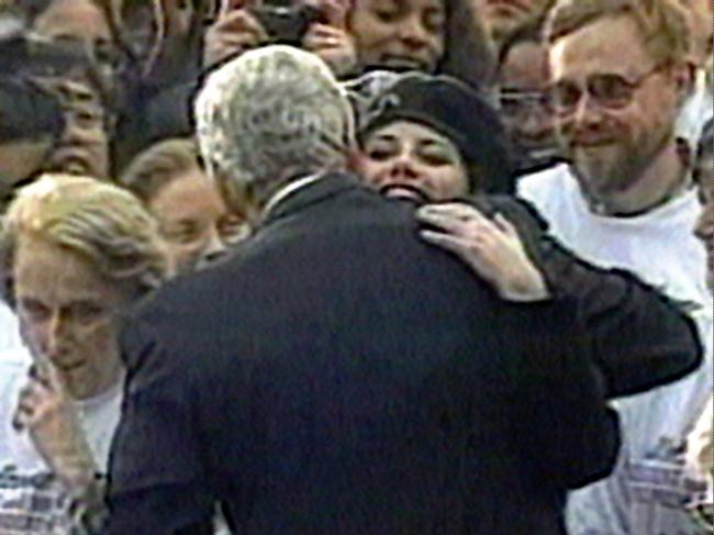 Intern Monica Lewinsky embraces US President Bill Clinton during a White House lawn party in Washington.