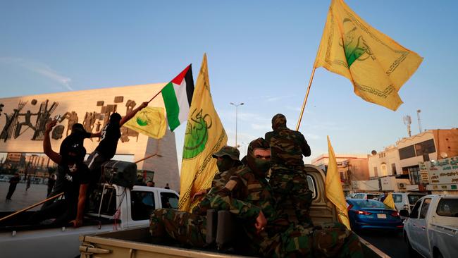 Iraq's Shiite Muslim al-Nujaba movement wave the Palestinian flag during a rally in Baghdad to express their support of the Operation Al-Aqsa Flood.