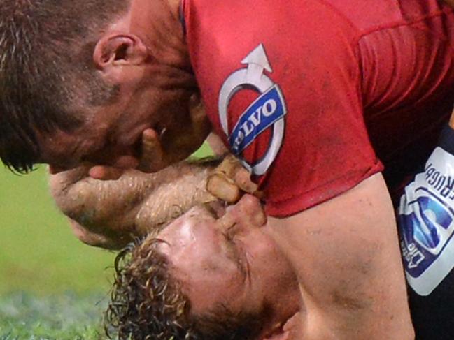 BRISBANE, AUSTRALIA - MAY 17: Ed O'Donoghue of the Reds and Scott Higginbotham of the Rebels are involved in an altercation during the round 14 Super Rugby match between the Reds and the Rebels at Suncorp Stadium on May 17, 2014 in Brisbane, Australia. (Photo by Bradley Kanaris/Getty Images)